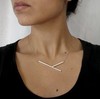 Minimal wearable sculpture made out of sterling silver tubes. Hang elegantly on a 17" stainless steel cable.