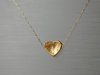 http://www.etsy.com/listing/83546467/heart-gold-pendant-hand-hammerd